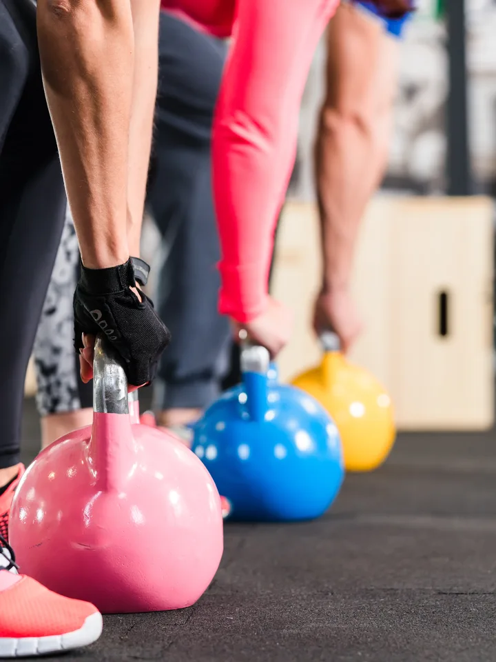 Athletes training with kettlebells during a crossfit workout